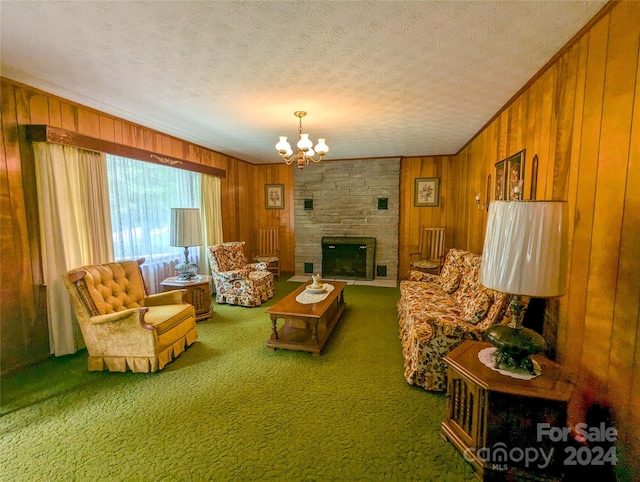 living room featuring wooden walls, carpet flooring, a stone fireplace, and a textured ceiling