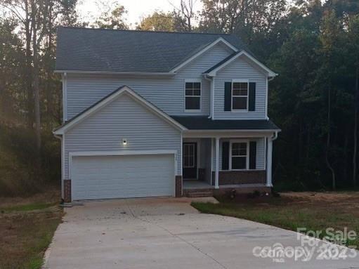 front of property featuring a garage and covered porch