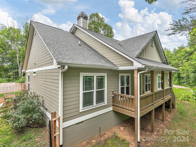 view of side of home with a deck