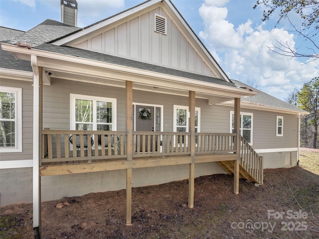 exterior space featuring covered porch, a shingled roof, crawl space, board and batten siding, and a chimney