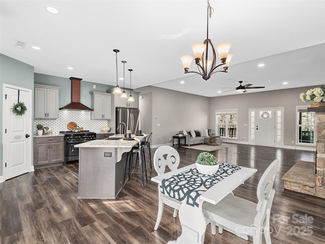 dining area featuring a wealth of natural light, dark wood-type flooring, and visible vents