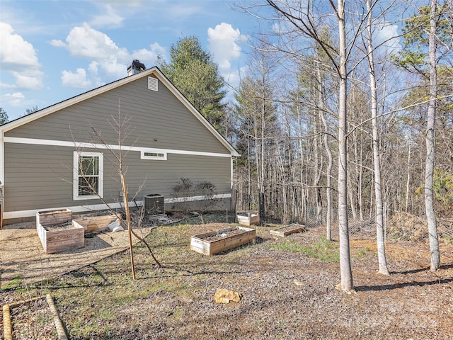 back of house with a vegetable garden