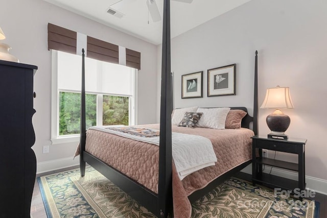 bedroom with ceiling fan and wood-type flooring