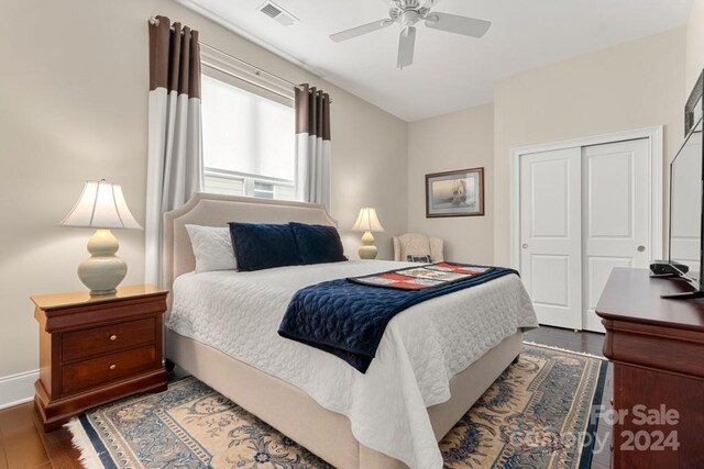 bedroom featuring dark hardwood / wood-style flooring, a closet, and ceiling fan