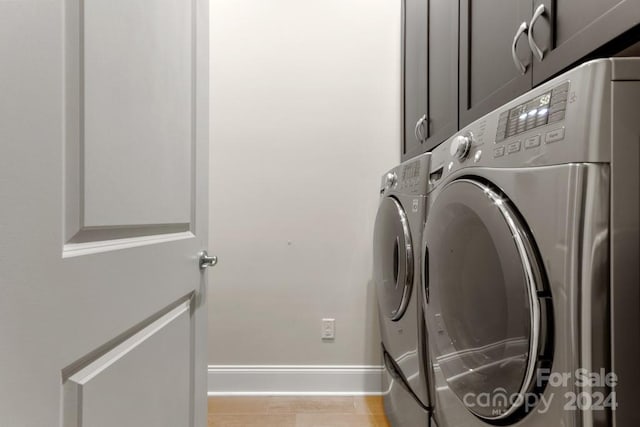 laundry area featuring cabinets and washer and dryer