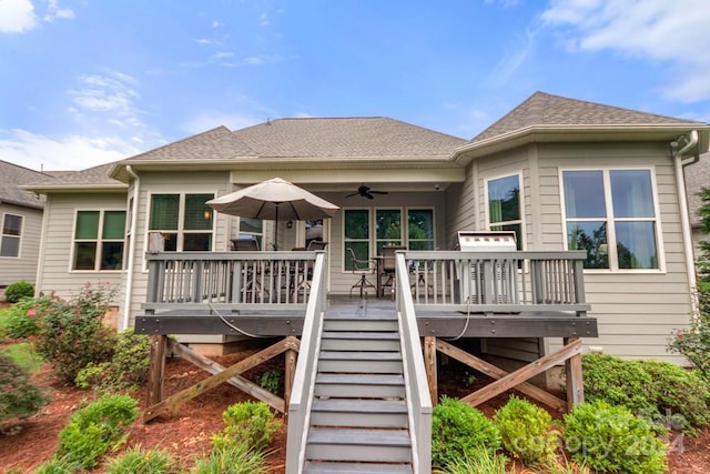 rear view of house with a wooden deck and ceiling fan