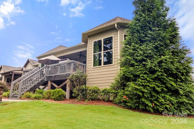 view of property exterior featuring a gazebo, a yard, a deck, and ceiling fan