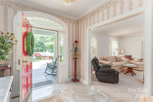 foyer with crown molding and light tile patterned floors