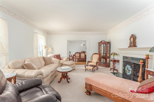 living room featuring a premium fireplace, crown molding, and carpet flooring