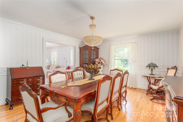 dining room featuring ornamental molding and light hardwood / wood-style floors