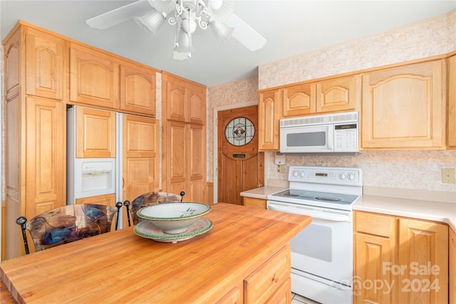 kitchen with decorative backsplash, white appliances, light brown cabinetry, and ceiling fan