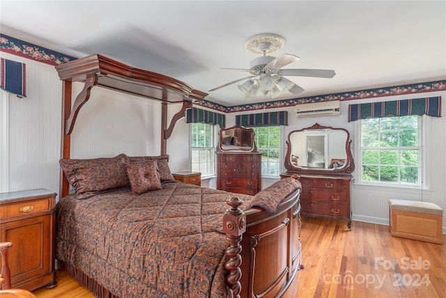 bedroom with light hardwood / wood-style flooring, multiple windows, and ceiling fan