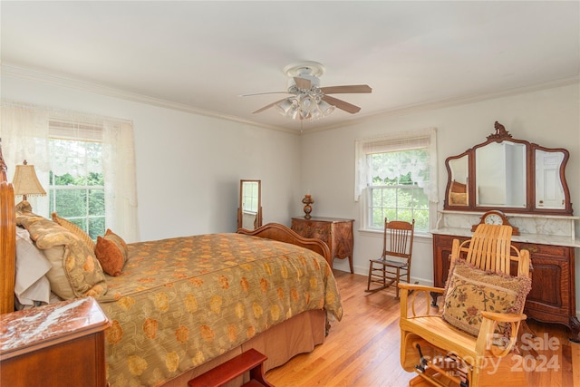 bedroom with ornamental molding, ceiling fan, and light wood-type flooring