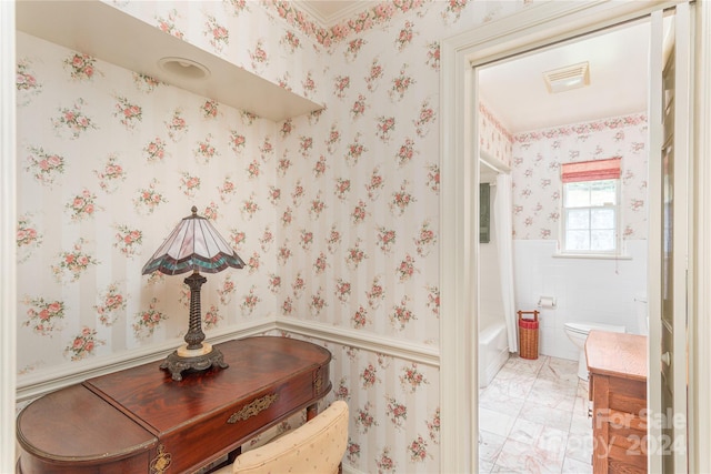 bathroom with shower / washtub combination, tile patterned flooring, and toilet