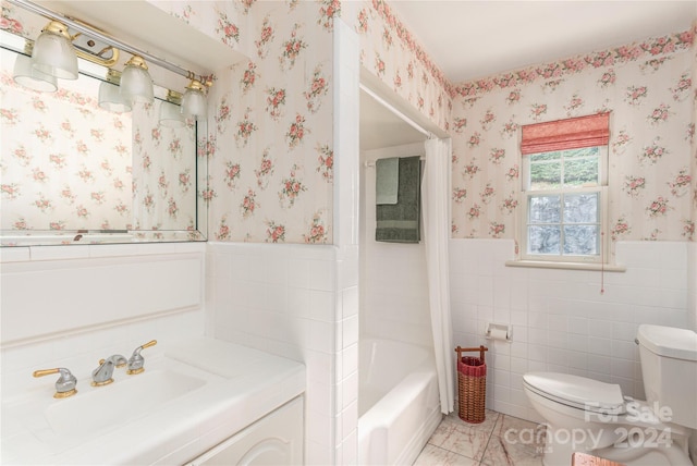 full bathroom featuring tile walls, tile patterned flooring, shower / washtub combination, toilet, and vanity