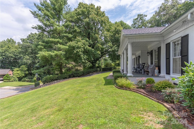 view of yard featuring covered porch