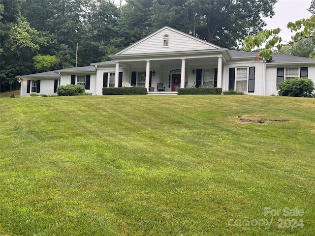 neoclassical home with a front yard