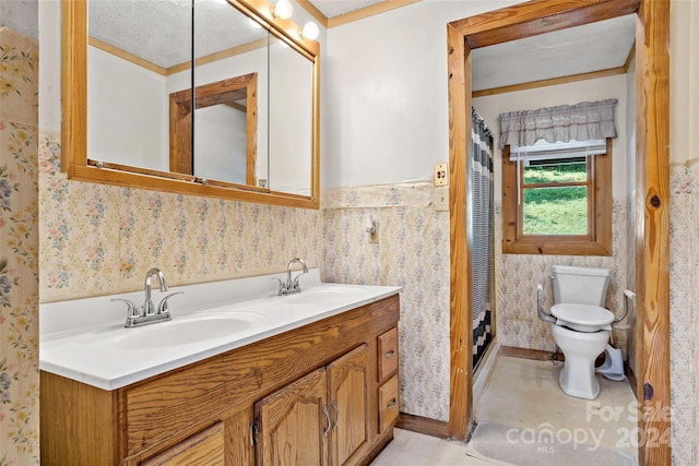 bathroom with vanity, a textured ceiling, and toilet