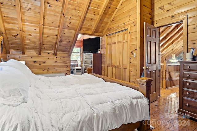 bedroom with lofted ceiling with beams, a closet, wood-type flooring, wood walls, and wooden ceiling