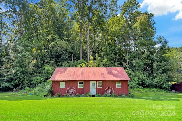 exterior space with a front yard and an outbuilding