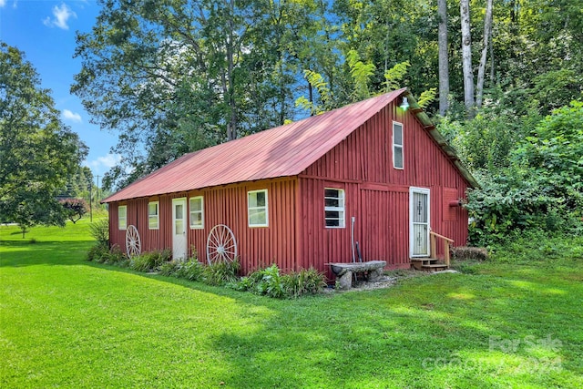 view of outbuilding featuring a lawn