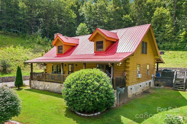 cabin with crawl space, log exterior, metal roof, and a front lawn