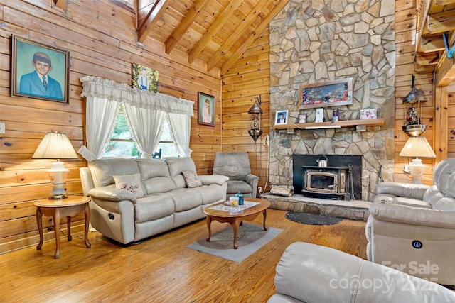 living room with high vaulted ceiling, beamed ceiling, wooden walls, wood finished floors, and wood ceiling