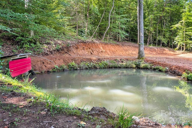view of water feature with a forest view