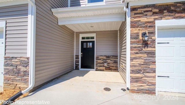 doorway to property with a garage