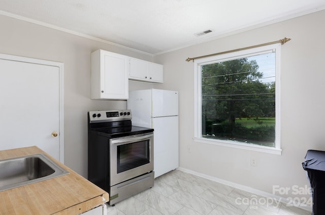 kitchen featuring stainless steel range with electric stovetop, a healthy amount of sunlight, white cabinets, and white fridge