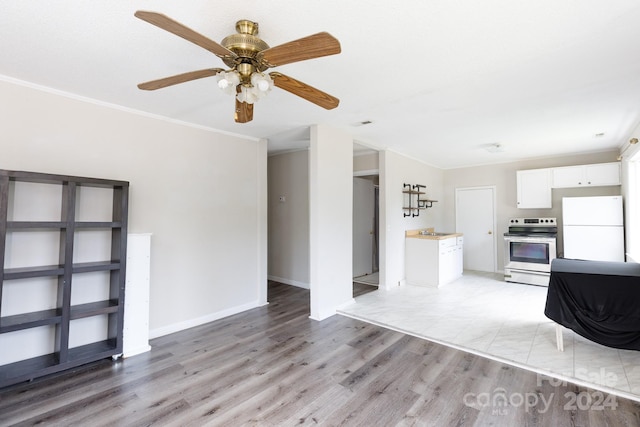 unfurnished living room featuring ornamental molding, sink, and light hardwood / wood-style floors