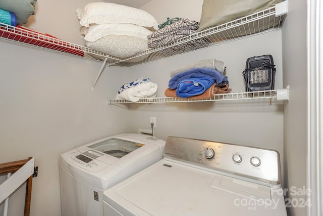 clothes washing area with washing machine and clothes dryer