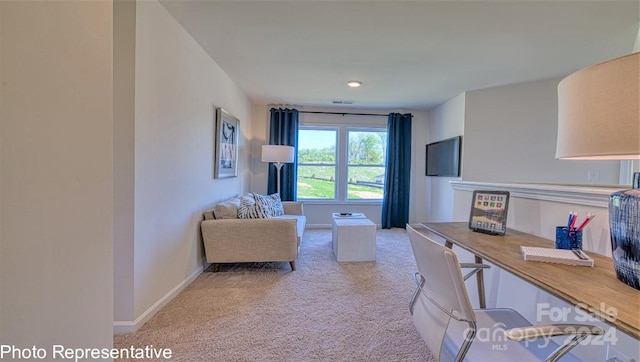 home office featuring baseboards, visible vents, and light colored carpet