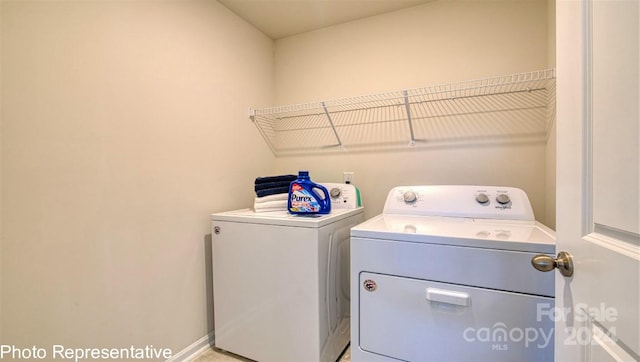 laundry room featuring washer and dryer, laundry area, and baseboards