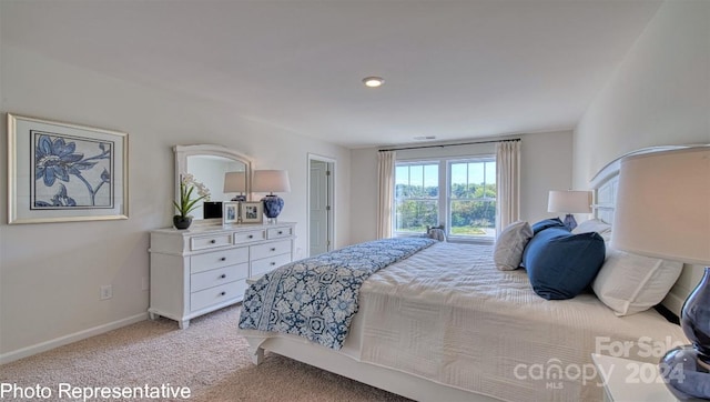 bedroom featuring light carpet and baseboards