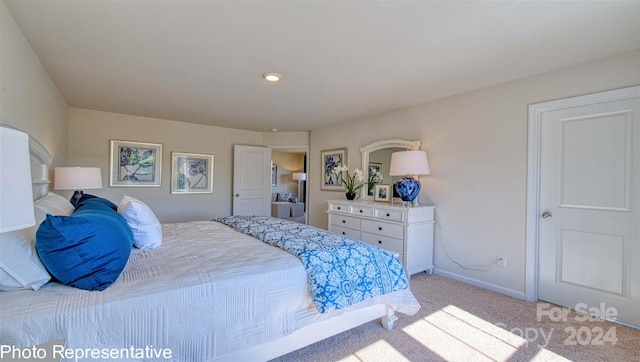 bedroom featuring light carpet and baseboards