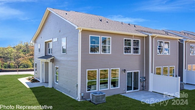 back of house featuring a yard, central AC unit, a patio, and a shingled roof