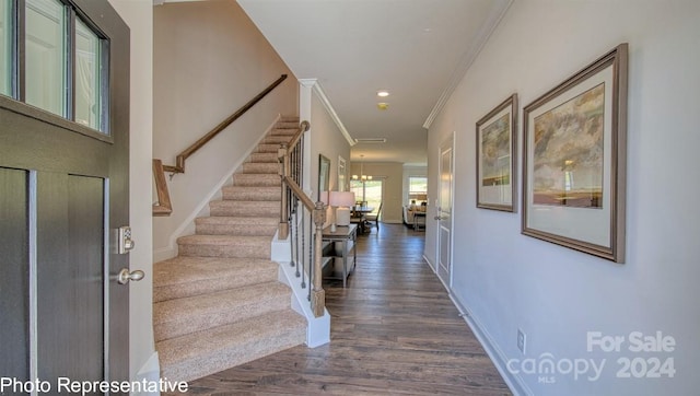 entryway with ornamental molding, stairway, dark wood finished floors, and baseboards