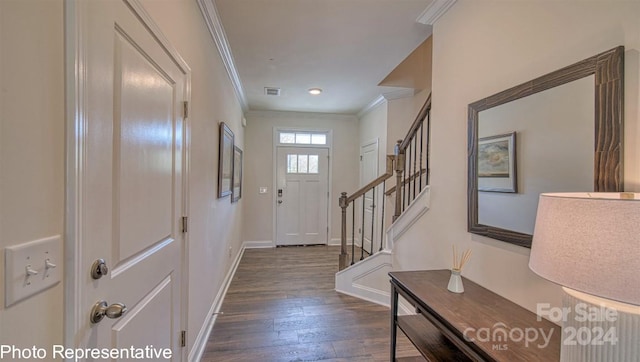 foyer featuring dark wood-style flooring, visible vents, baseboards, ornamental molding, and stairway