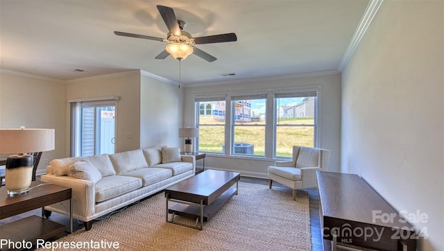 living room with baseboards, visible vents, a ceiling fan, ornamental molding, and wood finished floors