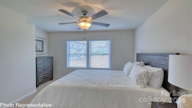 carpeted bedroom featuring baseboards and a ceiling fan