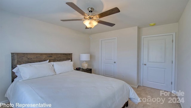 bedroom featuring ceiling fan, baseboards, and light colored carpet