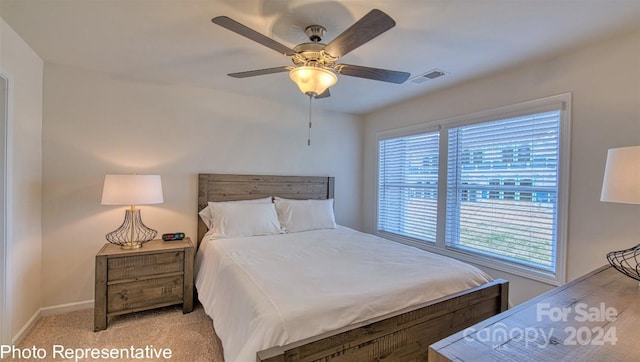 bedroom featuring light carpet, ceiling fan, visible vents, and baseboards