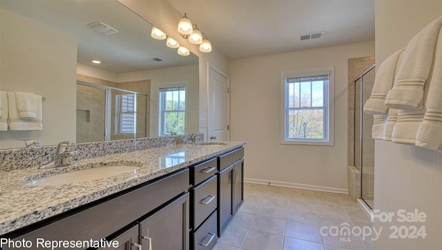 bathroom with baseboards, a sink, visible vents, and tile patterned floors