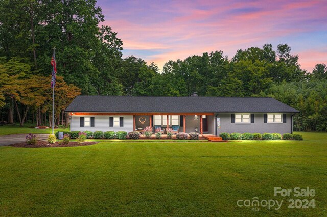 ranch-style home featuring a yard