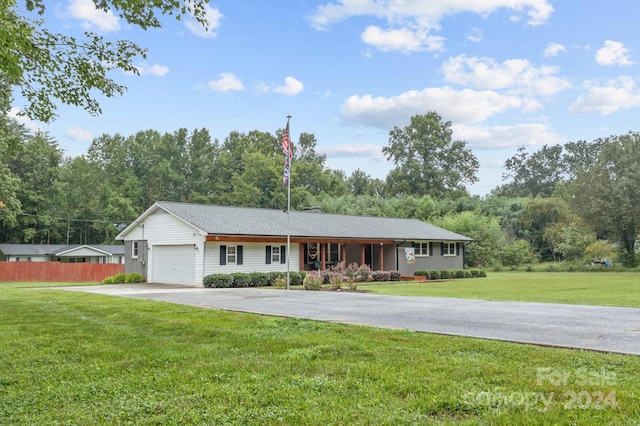 ranch-style house with a garage and a front lawn