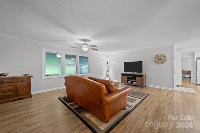 living room with crown molding, ceiling fan, light hardwood / wood-style flooring, and a textured ceiling