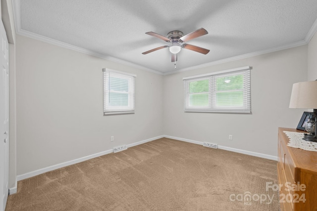 unfurnished room featuring carpet, ceiling fan, and ornamental molding