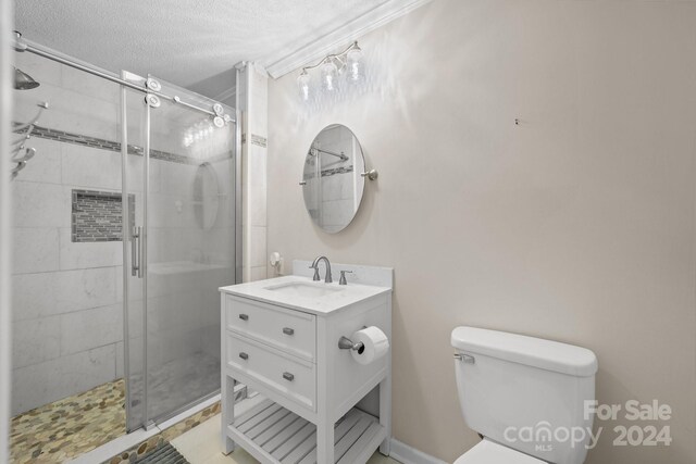 bathroom featuring a shower with door, tile patterned flooring, a textured ceiling, toilet, and vanity