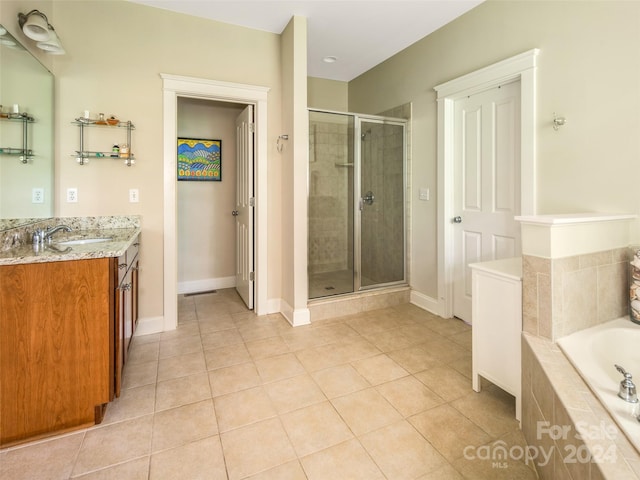 bathroom featuring vanity, independent shower and bath, and tile patterned flooring